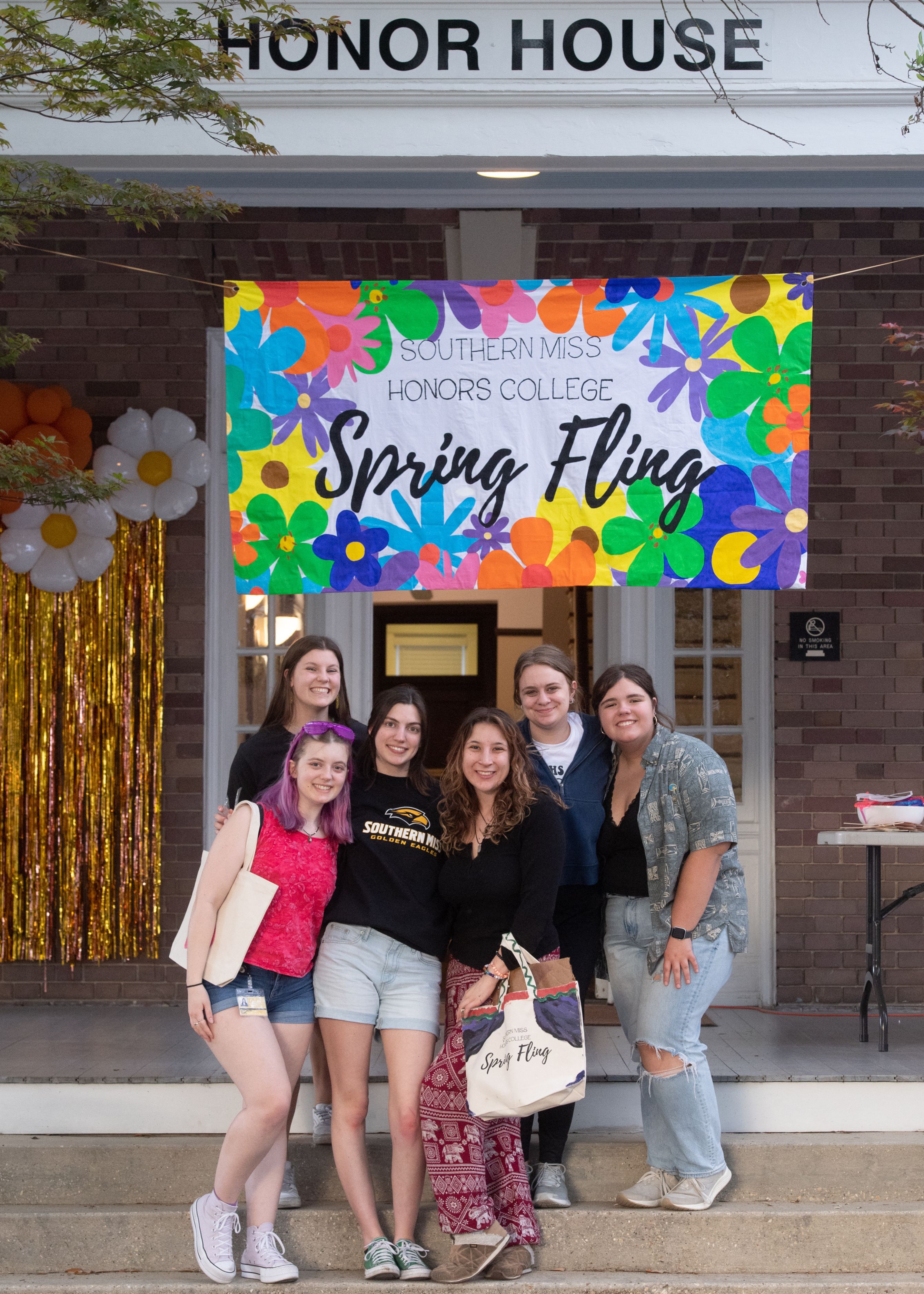 Honors students standing in front of the Honor House at Spring Fling