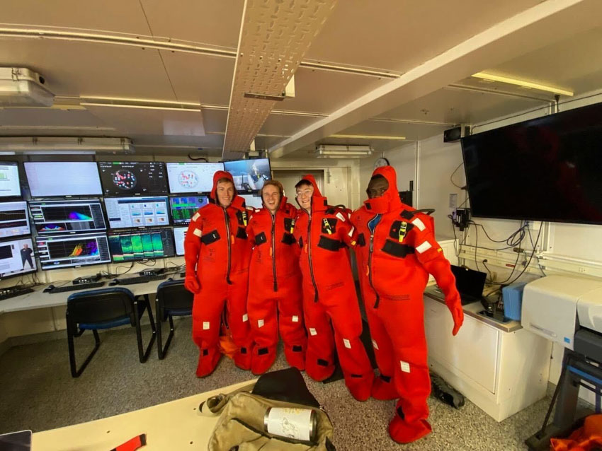 Mujeeb Abdulfatai (right) along with other scientists participate in a safety drill aboard the R/V Sally Ride. Array