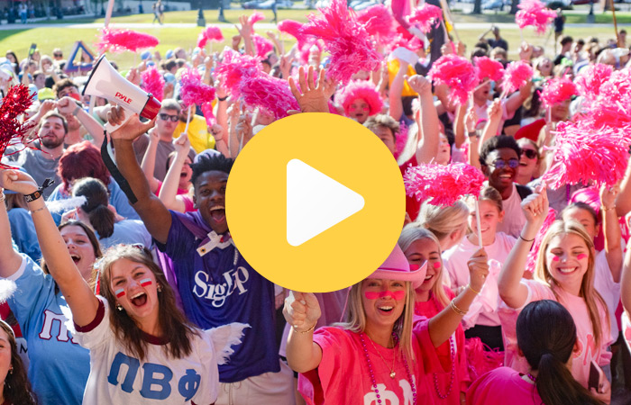 Group of students cheering in pink and blue
