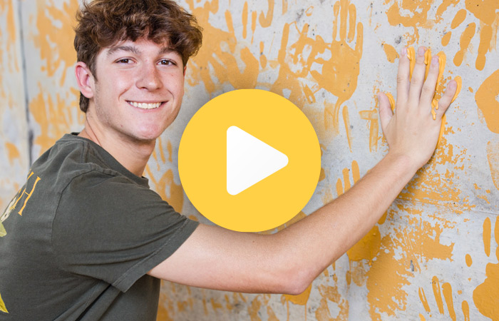 a student painting the eagle walk - play video