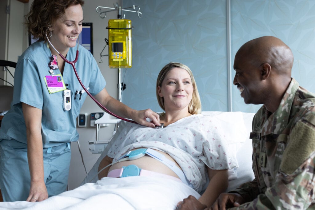 Maternity image shows parents-to-be interacting with a registered nurse.