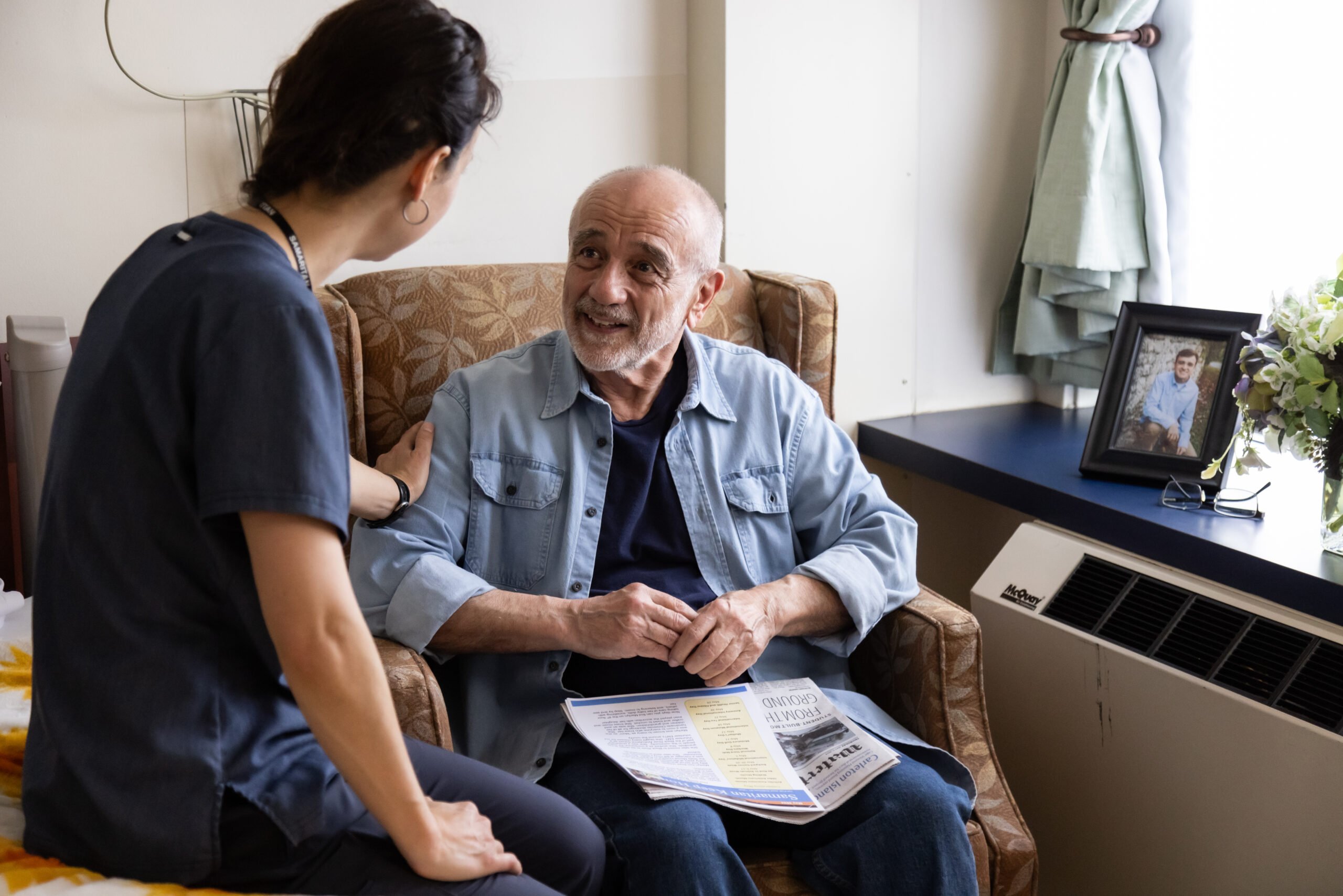 Samaritan Long Term Care resident at a Samaritan Keep Home unit. Visual: resident chatting with a staff member