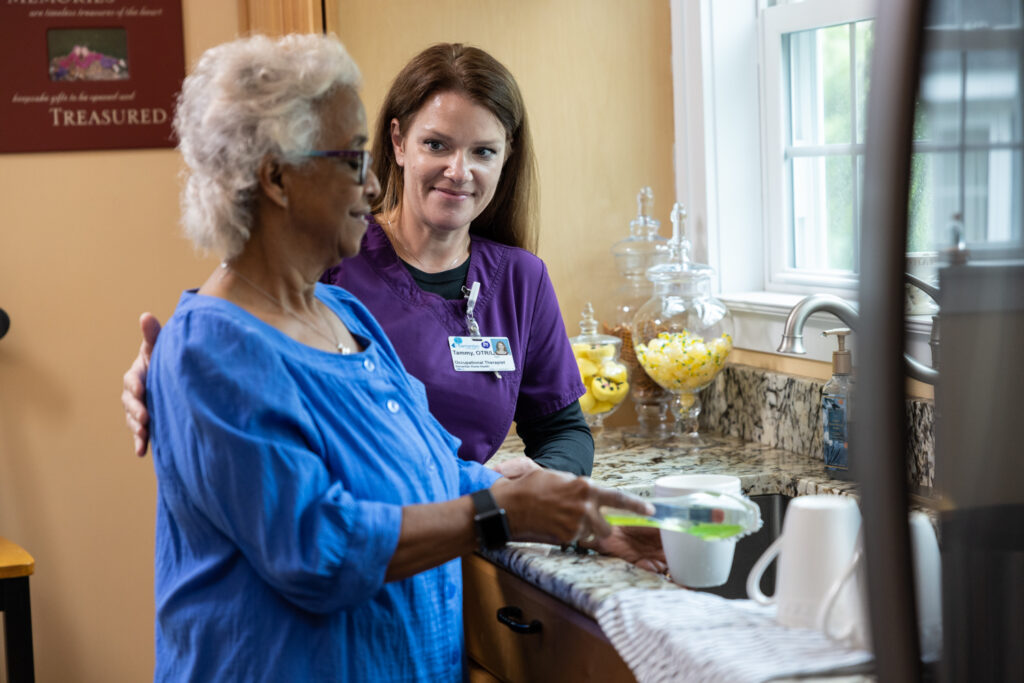Home Health Occupational Therapist Tammy Perez aids a patient washing dishes